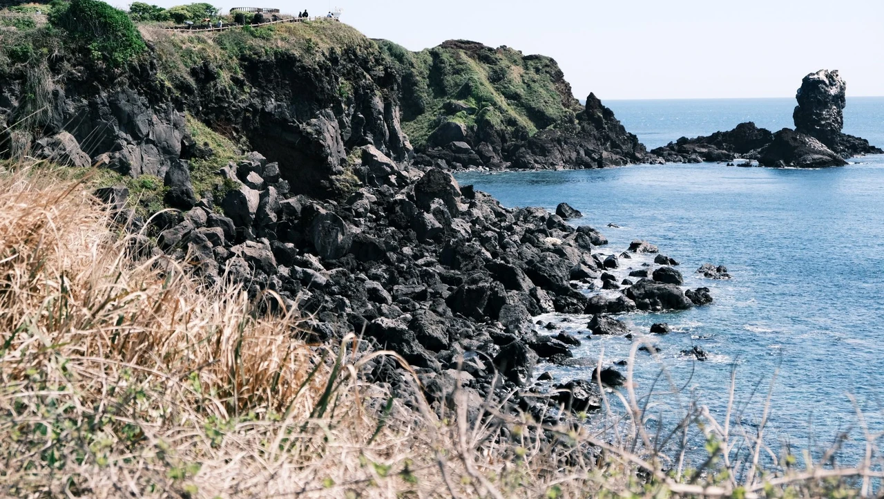 Rocky coastline and clear blue water on Jeju Island, South Korea, a popular relaxed base for remote workers
